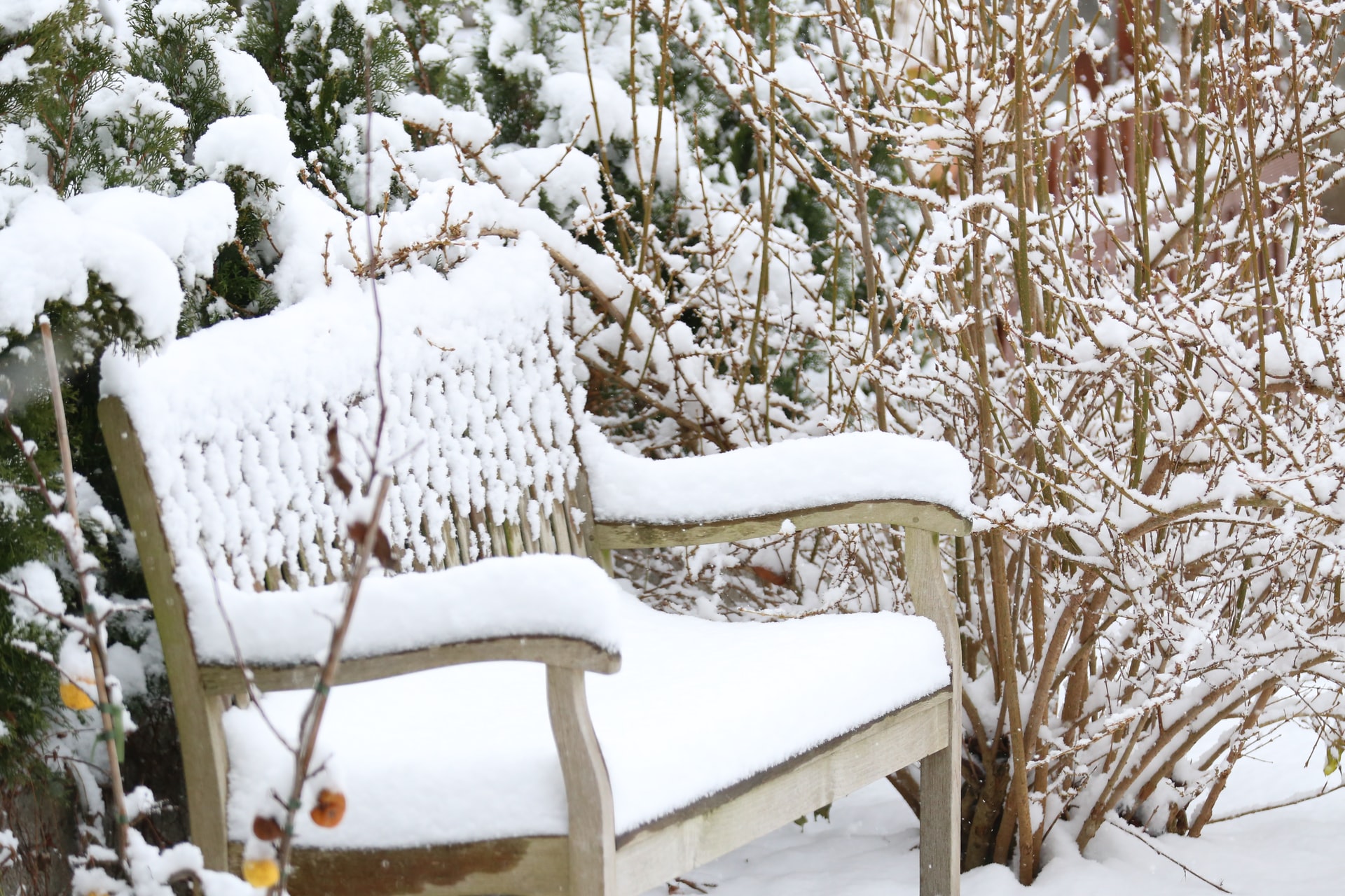 Garden furniture in winter covered in snow